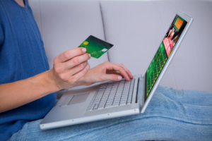 An online bettor using a credit card to make an online payment to a sports betting website.